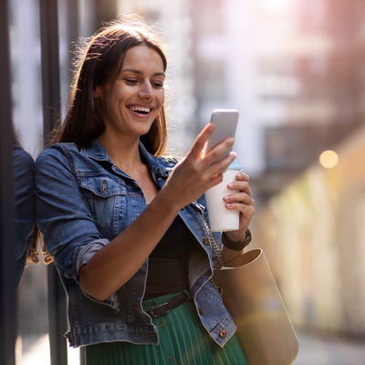 a woman smiling looking at something on her phone